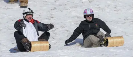  ??  ?? Coun. Terry Whitehead, left, and Mayor Fred Eisenberge­r neck-and- neck in their sled race.