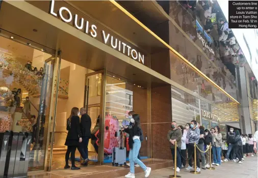  ?? ?? Customers line up to enter a Louis Vuitton store in Tsim Sha Tsui on Feb. 12 in Hong Kong.