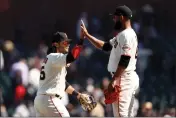  ?? EZRA SHAW — GETTY IMAGES ?? The Giants' Brandon Crawford, left, high-fives Jarlin Garcia after they beat the Rockies at Oracle Park on Wednesday in San Francisco.