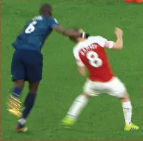  ??  ?? No malice: Pogba’s flailing arm clouts Ramsey