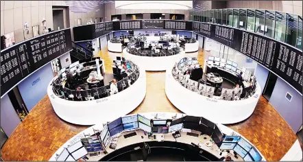  ??  ?? General view of the trading room at the German stock market pictured in Frankfurt, Germany, on March 27. German business morale hit its highest level
in nearly six years in March suggesting company executives are brushing off concerns about the threat...