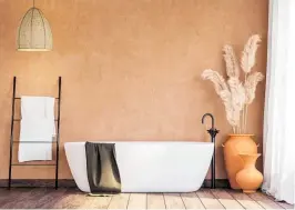  ??  ?? Above: A local style bathroom with blank orange wall, old wood floor, rattan lamp and terracotta jars with dried reed flowers.
Left: Beige and green-coloured furniture with wooden elements. Photos / Supplied