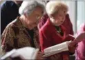  ?? ERIC BONZAR — THE MORNING JOURNAL ?? Dorothy Robbins, of Lorain, sings along from a hymnal during the Ash Wednesday service.