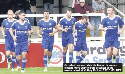  ??  ?? Gateshead players celebrate Danny Johnson’s (second right) 26th-minute equaliser in the narrow defeat at Woking. PIcture: DAVID HOLMES
