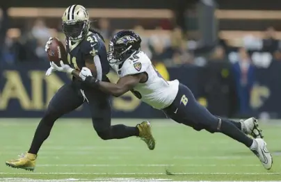  ?? JONATHAN BACHMAN/TNS ?? Ravens linebacker Roquan Smith, right, lays out to tackle Saints running back Alvin Kamara in the second quarter of Monday night’s game in New Orleans. No one is comparing Smith to a Hall of Famer like Ray Lewis, columnist Mike Preston writes, but the Ravens finally have a thumper in the middle.