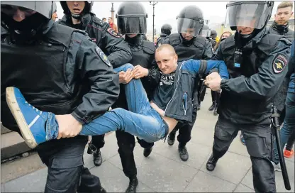  ?? Picture: AFP ?? MANHANDLED: Russian police officers detain a protester during an unauthoris­ed anti-Putin rally called by opposition leader Alexei Navalny on Saturday in Saint Petersburg, two days ahead of Vladimir Putin’s inaugurati­on for a fourth Kremlin term