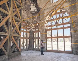  ??  ?? A Unesco assistant inside the damaged al-Nuri mosque.