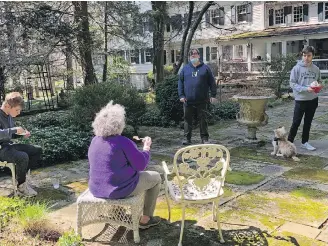  ?? KATIE WORKMAN ?? Katie Workman’s mother, back to camera, and family enjoying some socially distanced time and a meal on a pleasant spring day.