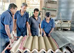  ?? ?? Substitute roofing sheet of sand and cement being made at NERD. Pix by Sameera Weeraseker­a