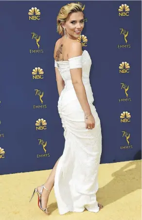  ??  ?? Scarlett Johansson made a statement on the gold carpet in a stunning white gown with a plunging neckline and high side slit.