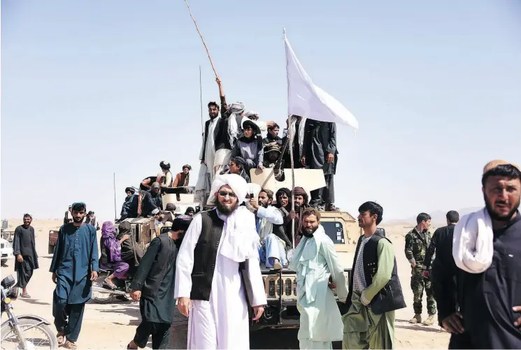  ?? JAVED TANVEER / AFP / GETTY IMAGES ?? Taliban and Afghan security forces celebrated a historic Eid ceasefire in June in Kandahar, a signal fighters on both sides are fed up with the conflict.