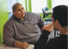  ?? Michael Short / Special to The Chronicle ?? Case manager Desarie Abeyta works with a homeless youth at the Bill Wilson Center’s drop-in center in San Jose.