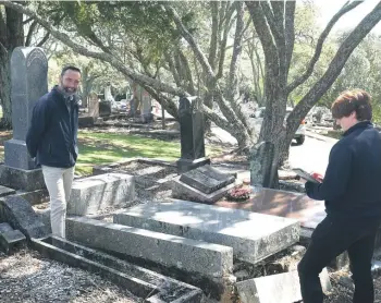  ?? ?? Purewa staff assess the risk and restoratio­n of tombstones and old graves in D block, one of the oldest parts of the 135-year-old cemetery.