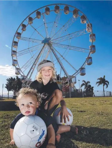  ??  ?? EYE CATCHING: Dylan Sinnott, 10, and his brother Kyle, 18 months, in front of the Reef Eye ferris wheel when it was in Cairns last year.