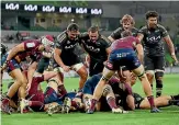  ?? GETTY IMAGES ?? Somewhere under that mass of bodies, Tyrel Lomax scores a try for the Hurricanes against the Reds in Melbourne last weekend.