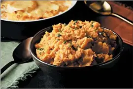  ??  ?? Sweet potatoes stand in for the usual suspects in this Thanksgivi­ng dinner mash flavored with coconut milk for a rich, tropical and nondairy texture enhancer.