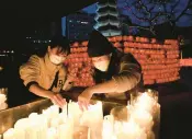  ?? CHUNG SUNG-JUN/GETTY ?? People light candles to celebrate the new year Saturday at a temple in Seoul, South Korea.