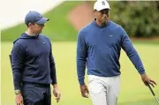 ?? Ross Kinnaid/Getty Images ?? On side: Rory McIlroy of Northern Ireland, left, and Tiger Woods of the US./