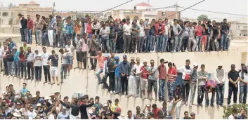  ?? — Reuters ?? Mourners gathers in front of the house of a dead man hit by a police vehicle at job demonstrat­ions in Tatouine.