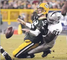  ?? MIKE ROEMER/ AP
ARCHIVES ?? Aaron Curry, here tackling the Packers’ Aaron Rodgers during a 2011 game, is back on the Raiders’ active roster. The team had to activate, waive or put him on seasonendi­ng injured reserve Tuesday.