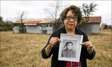  ?? JAY JANNER / AMERICAN-STATESMAN FILE ?? Georgia Steen, 71, holds a photo of herself as a student at the Montopolis Negro School. In December 2016, she arrived at the historic school to protest the planned demolition and eminent domain effort.