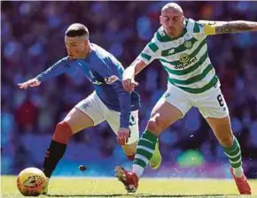  ?? REUTERS PIC ?? Rangers’ Ryan Kent (left) in action with Celtic’s Scott Brown in their match on Sunday.