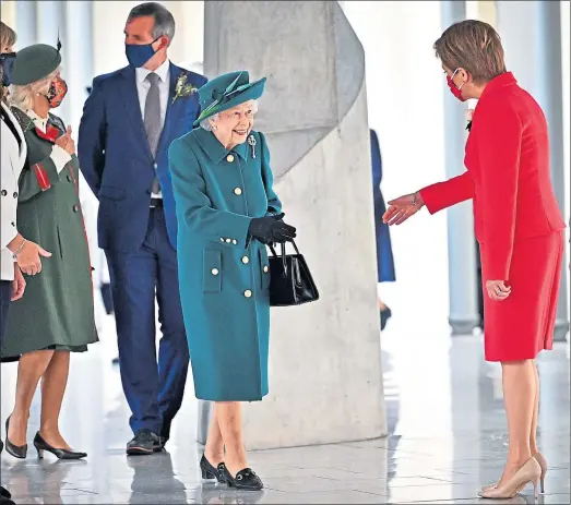  ?? Picture Jeff Mitchell ?? The Queen is greeted by Nicola Sturgeon as she arrives at Holyrood yesterday