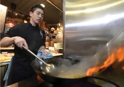  ?? AARON HARRIS PHOTOS FOR THE TORONTO STAR ?? Eric Chong cooks hand-cut noodles in the open kitchen at R&D. He will come out to meet fans and pose for pictures if asked.