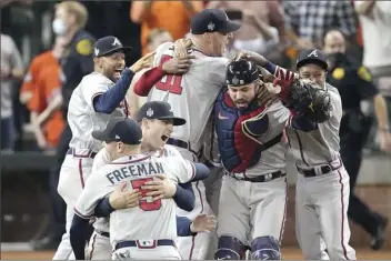  ?? AP photos ?? FROM TOP PHOTO: The Braves celebrate after the final out Tuesday.