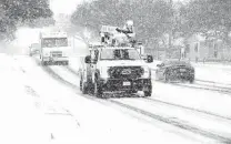  ?? Kin Man Hui / Staff photograph­er ?? CPS Energy crews drive in the snow Feb. 18. The city’s handling of the winter storm crisis is the subject of three investigat­ions.