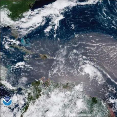  ?? NOAA VIA AP ?? In this geocolor image GOES-16 satellite image taken Sunday at 15:00 UTC, shows Tropical Storm Beryl, center right, moving across the Lesser Antilles in the eastern Caribbean Sea, and Tropical Storm Chris, top left, off the U.S. East Coast.