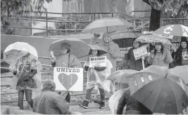  ?? ALLEN J. SCHABEN Los Angeles Times/TNS ?? Los Angeles Unified School District employees strike in the rain at Farmdale Elementary School in El Sereno on Tuesday.