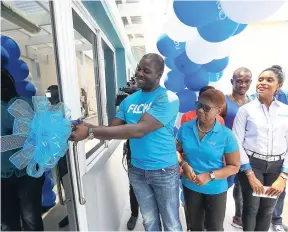  ??  ?? BELOW: Stephen Price, managing director at FLOW Jamaica, cuts the ribbon to the new FLOW Flex Gym. Looking on (from left) are Mauleen Haynes, employee relations manager; Kecia Taylor, FLOW legal counsel and a member of the gym management committee; and...