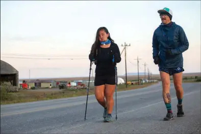 ?? Photo by James Mason ?? TELLER TO NOME— Carol Seppilu and Tim Lemaire concluded their run from Teller to Nome on Sunday. Seppilu runs with the purpose to bring suicide prevention awareness to the region.