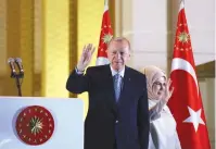  ?? (Umit Bektas/Reuters) ?? TURKISH PRESIDENT Recep Tayyip Erdogan and his wife, Ermine, wave to supporters from the Presidenti­al Palace in Ankara after his election victory yesterday.