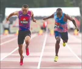  ?? The Canadian Press ?? Andre De Grasse, left, of Toronto, powers over the finish line to win gold in the men’s 100-metre race at the Canadian Track and Field Championsh­ips in Ottawa on Friday. At right is Gavin Smellie, who finished third.