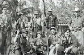  ??  ?? Militiamen pose at a base camp on a confiscate­d plantation, 14 February 1961