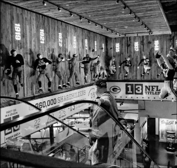  ??  ?? Visitors explore Green Bay Packers history Friday inside the team’s Hall of Fame at Lambeau Field. The stadium hosts several daily tours.