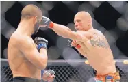  ?? AP FILE ?? Donald Cerrone, shown during a 2015 fight, is upset that Mike Winkeljohn agreed to train his next opponent.