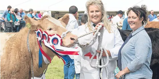  ??  ?? Rebecca Stuart, of Huntly, and Debbie Watt with Gold Rush, the winner of the overall cattle championsh­ip at Fettercair­n Show.