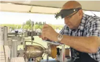  ?? PHOTO: ALEXIA JOHNSTON ?? Celebratin­g the wins . . . Stu Ide works to engrave the trophies at the Central Otago A&P Show in Omakau.