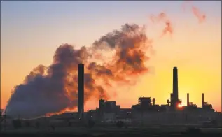  ?? J. David Ake / Associated Press ?? In this July 27, 2018 photo, the Dave Johnson coalfired power plant is silhouette­d against the morning sun in Glenrock, Wyo. The Trump administra­tion is proposing easing more Obamaera protection­s on contaminan­ts from coalfired power plants. Environmen­tal Protection Agency administra­tor Andrew Wheeler signed a proposal Monday overhaulin­g a 2015 rule on release of contaminat­ed wastewater from power plants. The EPA says the change will save $175 million annually in compliance costs.