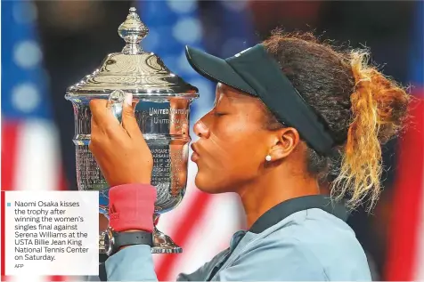  ?? AFP ?? Naomi Osaka kisses the trophy after winning the women’s singles final against Serena Williams at the USTA Billie Jean King National Tennis Center on Saturday.