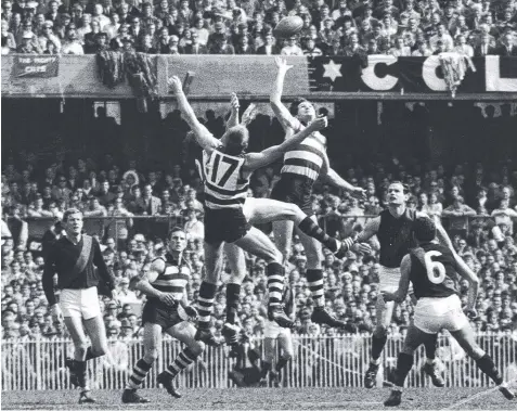  ??  ?? 1968: Chris Mitchell wins a hitout for Geelong in the preliminar­y final against Essendon, ahead of Sam Newman and Don McKenzie. Scouting around the pack are Ken Fletcher, Tony Polinelli, Ken Fraser and Geoff Gosper.