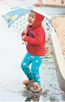  ?? CHERYL EVANS/THE REPUBLIC ?? Above: Three-year-old Jackson Lansing of Glendale, plays in the rain at Faith Bible Church in Glendale on Feb. 18.