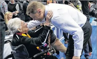  ?? AP PHOTO ?? Sister Jean Dolores Schmidt, a 98-year-old nun, greets Loyola-chicago coach Porter Moser as he walks off the court following his team first-round NCAA Tournament win Thursday. Sister Jean is Loyola-chicago’s biggest fan, in addition to being the team...