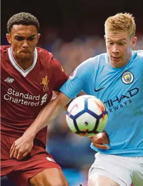  ?? REUTERS PIC ?? Manchester City’s Kevin De Bruyne (right) and Liverpool’s Trent Alexander-Arnold vie for the ball in the Premier League at Etihad Stadium on Saturday.