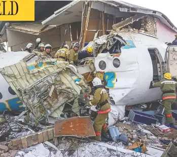  ?? KAZAKHSTAN’S EMERGENCIE­S COMMITTEE / AFP VIA GETTY IMAGES ?? Rescuers scour the wreckage of a passenger plane that crashed outside Almaty, Kazakhstan, early Friday. At least 12
people died after the Bek Air Fokker 100 struck a house shortly after takeoff from Kazakhstan’s largest city.