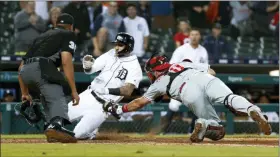  ?? PAUL SANCYA — THE ASSOCIATED PRESS ?? Philadelph­ia Phillies catcher J.T. Realmuto tags the Tigers’ Nicholas Castellano­s out at home plate in the 14th inning of a baseball game in Detroit, Tuesday.