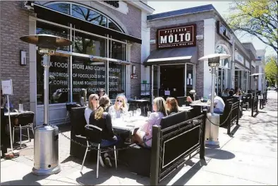  ?? Ned Gerard / Hearst Connecticu­t Media ?? Diners sits at the outdoor tables in front of Pizzeria Molto in Fairfield on May 20, 2020.